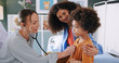 © peopleimages.com - Kid, mother and doctor with stethoscope for healthcare exam, heart check up and cardiology in clinic. Pediatrician, parent and woman with child for lung test, breathing or medical assessment on chest