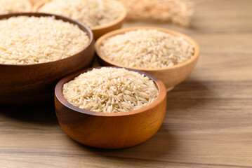 Wall Mural - Organic Jasmine brown rice seed in wooden bowl, Thai Rice, Food ingredient