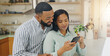 © peopleimages.com - Couch, smile and couple with smartphone, digital and research for home loan, online or newlyweds in lounge. Love, man and woman with tech for credit score, living room or planning for budget of house