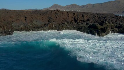 Wall Mural - Aerial drone view of mountain sea and volcanoes in Lanzarote, Canary Islands, Spain