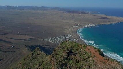 Wall Mural - Aerial drone view of mountain sea and volcanoes in Lanzarote, Canary Islands, Spain