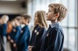 © fahmy - A student stands proudly in the front row, ready to lead the pledge. Their classmates stand behind them