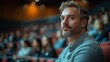 © Factory Stock - Thoughtful Man in Auditorium: A Contemplative Portrait