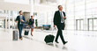 © peopleimages.com - Mature businessman, happy and suitcase at airport for international conference in lobby. Person, attorney and lawyer with baggage, luggage and trip to global convention for corporate law in hallway