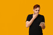 © Pixel-Shot - Shocked young man with mobile phone on yellow background. Black Friday sale