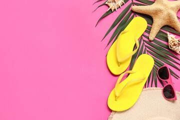 Wall Mural - Flip flops with seashells, sunglasses and tropical leaf on pink background