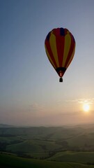 Poster - A single hot-air balloon drifting above rolling green hills at dawn, capturing an atmosphere of freedom and exploration.
