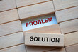 © JeromeMaurice - Problem and Solution text on wooden blocks representing problem solving business skill. Solution concept