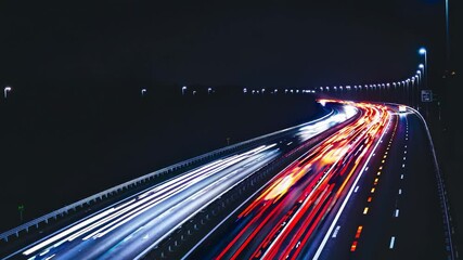 Poster - A long-exposure shot capturing neon streaks from passing cars and city streetlights, all blending into colorful, abstract trails against a pitch-black road.
