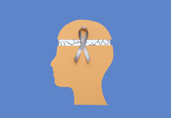 Wall Mural - Paper human head with brain and grey awareness ribbon on blue background. Cancer concept