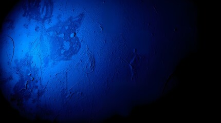 Wall Mural - A deep blue light illuminates part of a textured surface, creating an abstract and mysterious atmosphere. Shadows and variations in the blue hues add depth and intrigue.