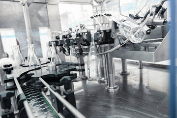 Poster - advanced machinery for bottling beverages in a modern production facility during daylight hours