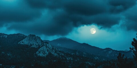 Sticker - Full moon shining over dark mountain range at night.