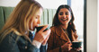 © peopleimages.com - Women, friends and laugh with drink at cafe with conversation, memory and funny joke for bonding. Girl, people and relax with talk, cappuccino and listening with chat, gossip or story at coffee shop
