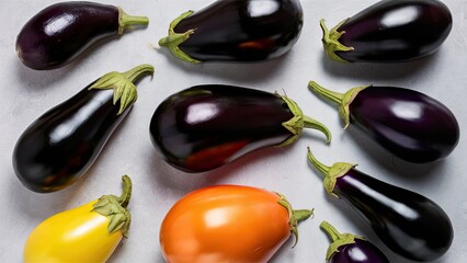 Poster - Various shapes and colors of aubergines and eggplants arranged on a light grey background with ample copy space, featuring deep purple, yellow, and orange hues.