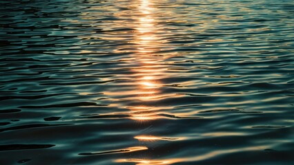 Aufkleber - Sparkling water surface reflecting a warm golden sunbeam creating a glare effect on gentle waves in shades of blue and green.