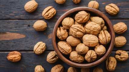 Poster - Walnuts arranged around a rustic wooden bowl filled with whole walnuts on a dark wooden surface creating a natural and organic aesthetic.