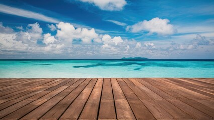 Poster - Serene ocean view with clear turquoise water and blue sky, contrasting with a warm brown wooden floor in the foreground under fluffy clouds