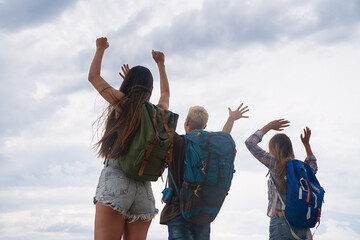 Wall Mural - group of backpacker friends with backpack traveling and enjoying the healthy lifestyle together