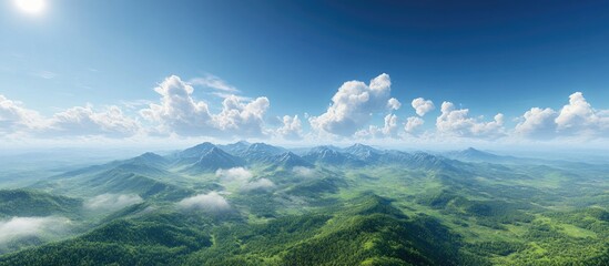 Wall Mural - Majestic aerial view of lush green mountainous terrain with vibrant blue sky and fluffy white clouds creating a serene natural landscape.