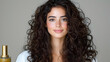 © BROPRADANA - Woman with curly hair, studio shot, beauty product