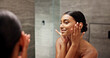 © peopleimages.com - Smile, skincare and mirror with woman in bathroom for beauty, morning routine and cosmetics. Shine, hotel resort and cleaning with reflection of person at home for grooming, spa glow and self care