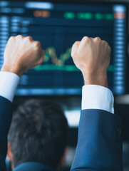 Poster - Victory in the Market: A triumphant businessman celebrates his success with clenched fists, triumphantly raised in front of a dynamic stock chart.