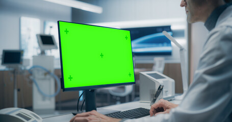 Aufkleber - A Male Scientist in a White Lab Coat Works on a Green Screen Computer in a Advanced Medical Lab, Focusing on Advanced Healthcare Research and Analysis in a High-tech Hospital Environment