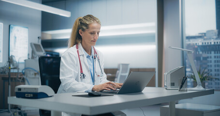 Aufkleber - Female Physician Works Diligently on a Laptop in a High-tech Hospital Office, Focusing on Medical Research and Patient Data Analysis in a Modern Clinical Setting. Portrait Shot