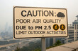 © F-STUDIO - A warning sign indicating poor air quality due to PM 2.5, advising to limit outdoor activities.