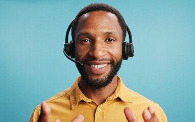 Wall Mural - Black man, headset and call centre portrait in studio, hotline employee and blue background. Male person, telemarketing consultant and helping with customer care, professional service and advisor