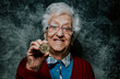 © oneinchpunch - Old woman portrait holding a Cryptocurrency coin