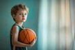 © Aleksandr - Young caucasian boy holding basketball near window in sports jersey