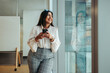 © Jacob Lund - Confident professional woman wearing stylish clothing in a modern office setting