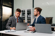 © NINENII - Diverse professionals collaborate on project analysis with financial graphs. Strategic teamwork and insights drive company growth and success.