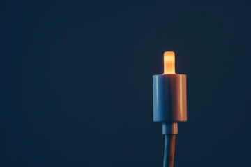 Fototapete - Close up of usb cable emitting warm orange light, suggesting power or data transfer