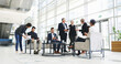 © peopleimages.com - Collaboration, development and meeting with business people in lobby of office for planning or strategy, Coaching, management and training with employee team in discussion of company workplace
