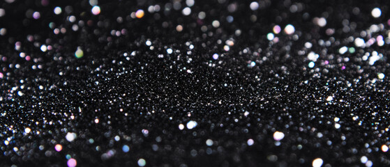 Poster - Glittering particles create a festive and sparkling texture on a dark backdrop