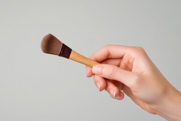 A person holding a paintbrush or artist's brush with artistic inspiration