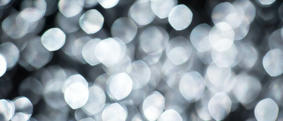 Poster - Light bokeh effects with hexagonal shapes on a structured black background