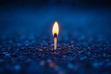 Poster - Single matchstick ignites with bright flame against a dark textured background in a dramatic display of light and shadow
