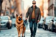 © Anna Lurye - A german shepherd guide dog supports a man wearing dark glasses while crossing a bustling street filled with cars and pedestrians