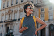 © bernardbodo - Tourist with backpack and smart phone exploring a european city