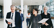 © peopleimages.com - Office, walking and group with documents, talking and preparation for speech, politics and serious. Corporate, reading and chancellor with team for meeting, colleagues and people with paperwork