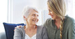 © BuyoutReese09/peopleimages.com - Senior, woman and happy together with daughter on sofa for bonding, relationship and weekend visit in retirement. Love, people and smile in home with connection, support and relax for conversation