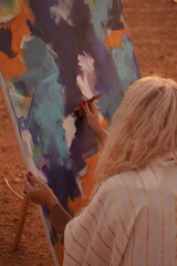 Wall Mural - Female Artist Painting Abstract Art in Desert at Sunset