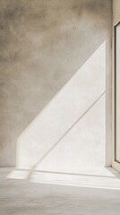 Poster - Natural light filters through a large window, illuminating a smooth, white plaster wall. The gentle shadows create an atmosphere of calmness and simplicity, inviting contemplation