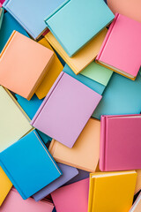 Poster - A colorful assortment of pastel-colored books stacked together, symbolizing creativity, learning, and education in a vibrant and playful setting.