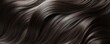 © Denys - Flowing black hair forming elegant waves, representing salon styling and hair health