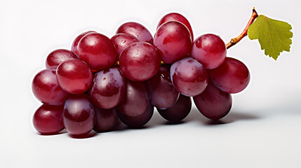 A bunch of red grapes with a leaf on top